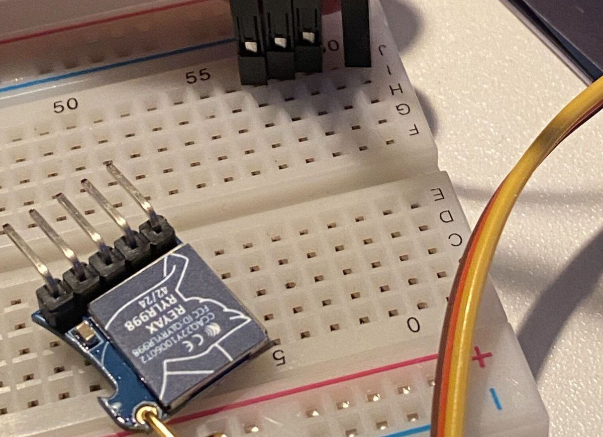 Radio module with a spring antenna on a breadboard