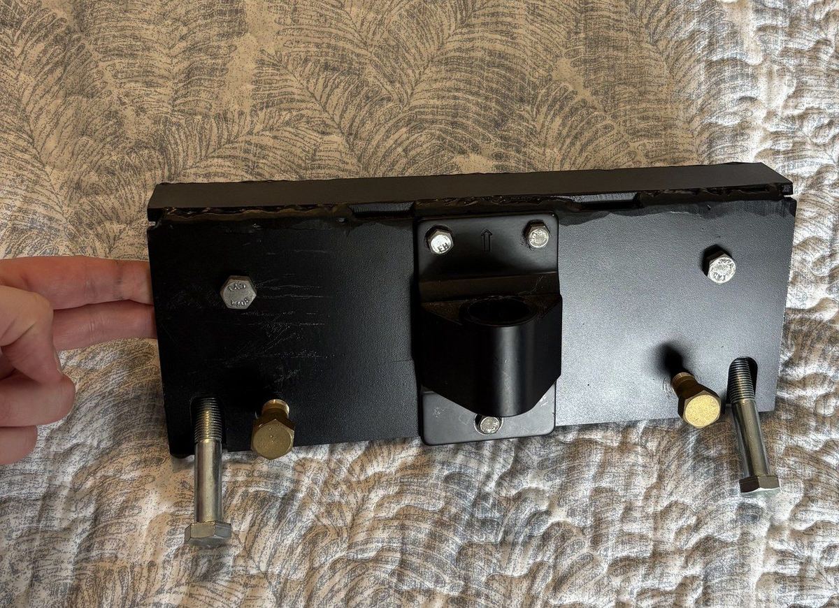 Black steel trolley plate with bolts and a center mount